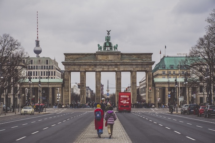 2 ladies walking towards Brandenburg Gate on a grey day in Berlin Germany