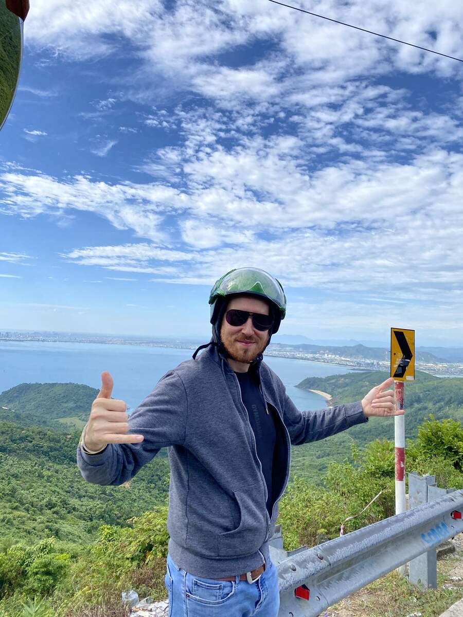 Man posing and enjoying the views in Hai Van Pass in Da Nang