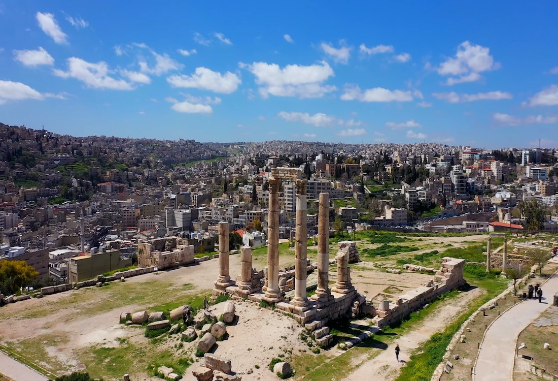 The Citadel ruins in Amman and the city in the background on a sunny day