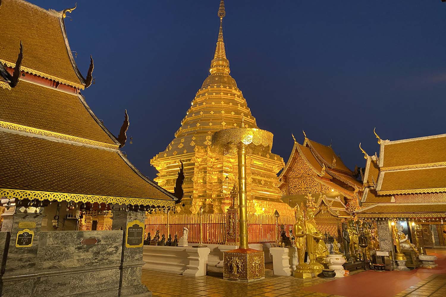The golden pagoda at Doi Suthep temple at night glowing