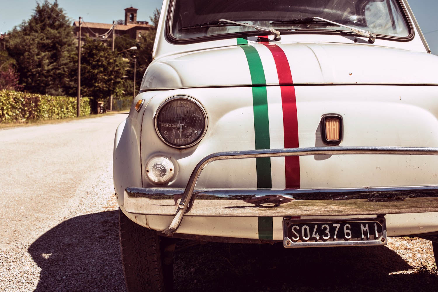 Old Fiat 500 car with an italian flag drawn on it