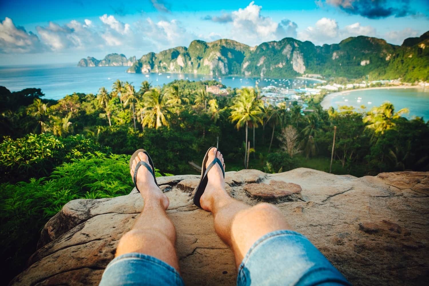 Person's legs with a tropical view.