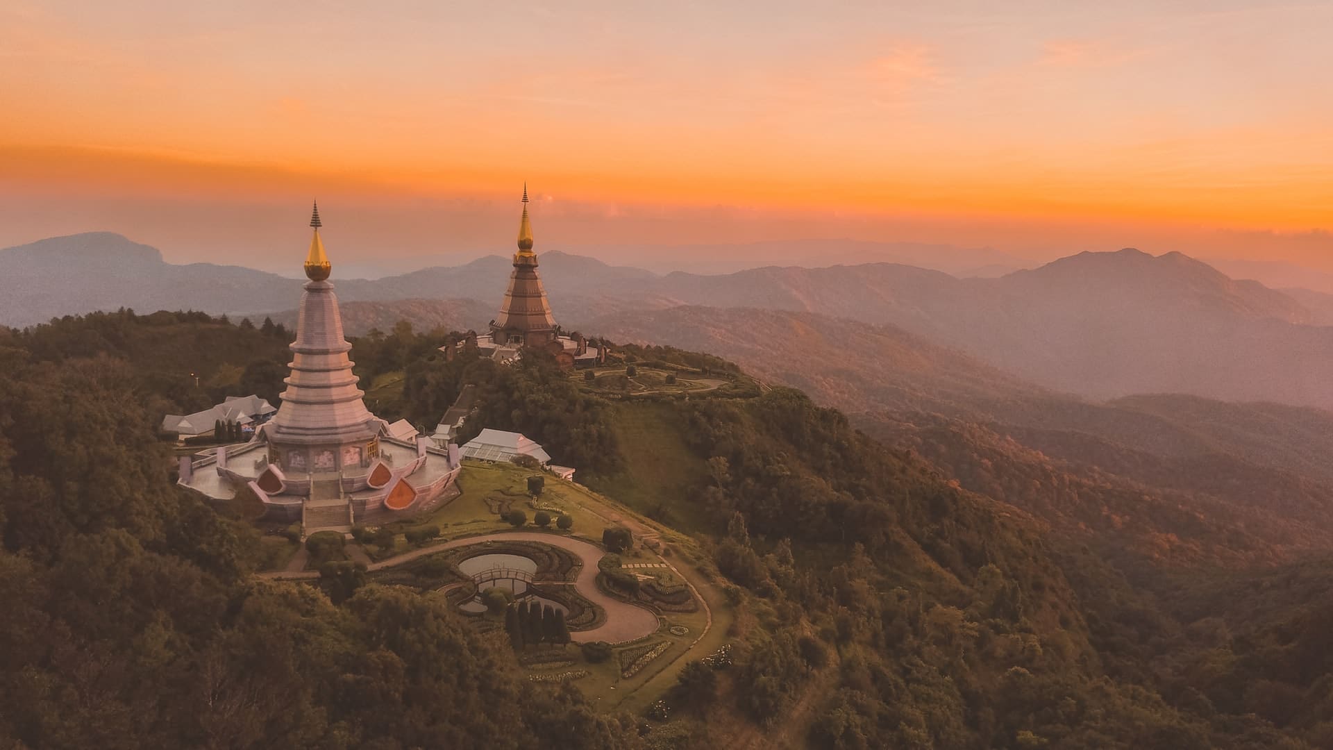 Hilltop view with a golden pagoda. View from Doi Inthanon during the sunrise
