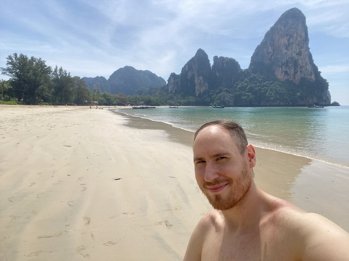 Man taking a selfie on a deserted beach in South Thailand