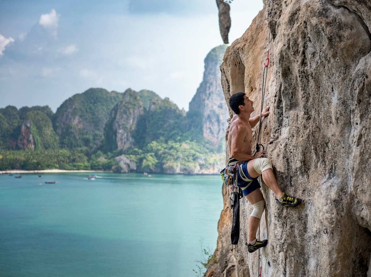 Man rock climbing in Railay Beach Thailand