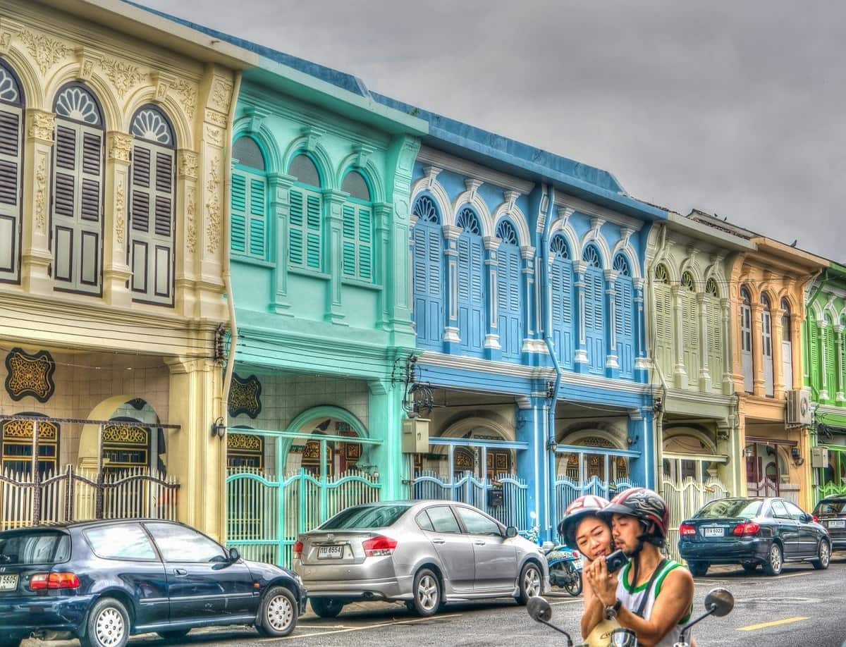 Colorful heritage buildings with balconies and people on a scooter