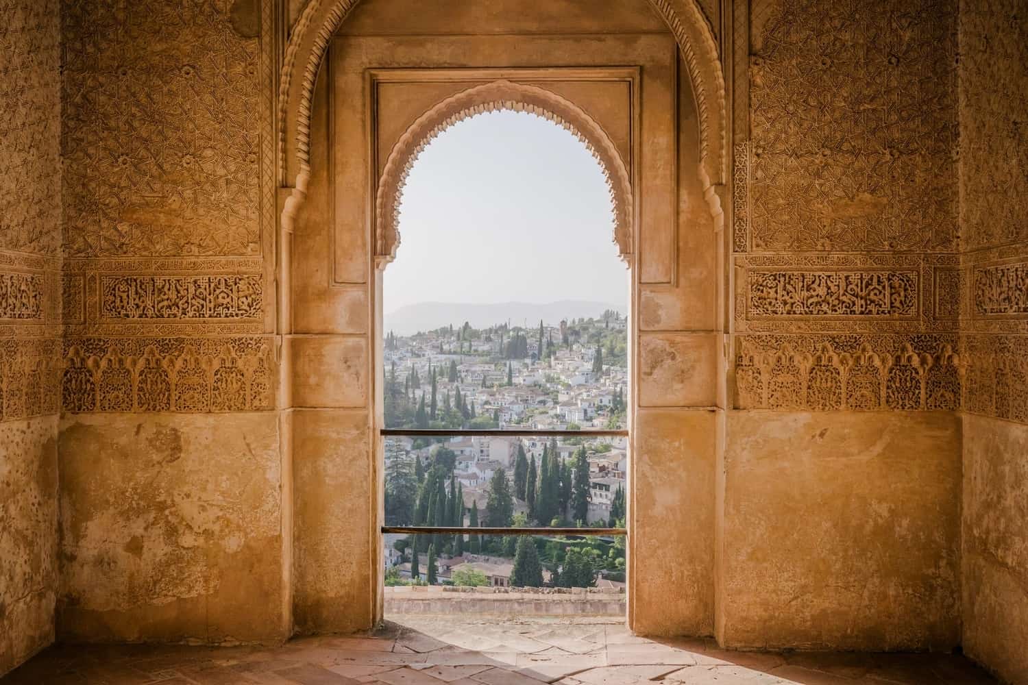 Archway looking out to a landscape from the Alhambra in Granada. unique places to visit in Spain