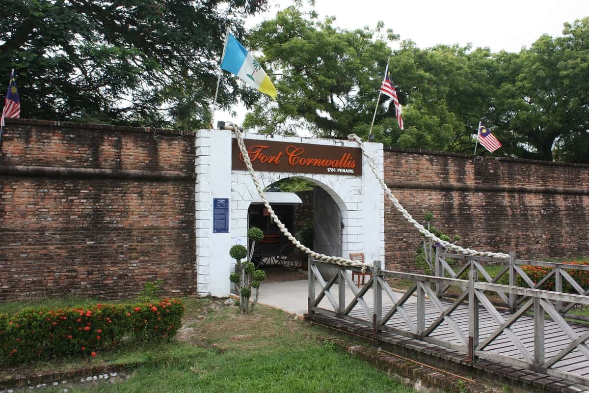 Historic fort entrance with flags.