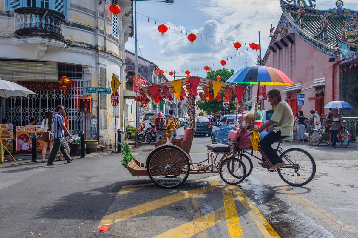 Street with red lanterns and a cyclist in Georgetown in Penang - places to visit in Penang