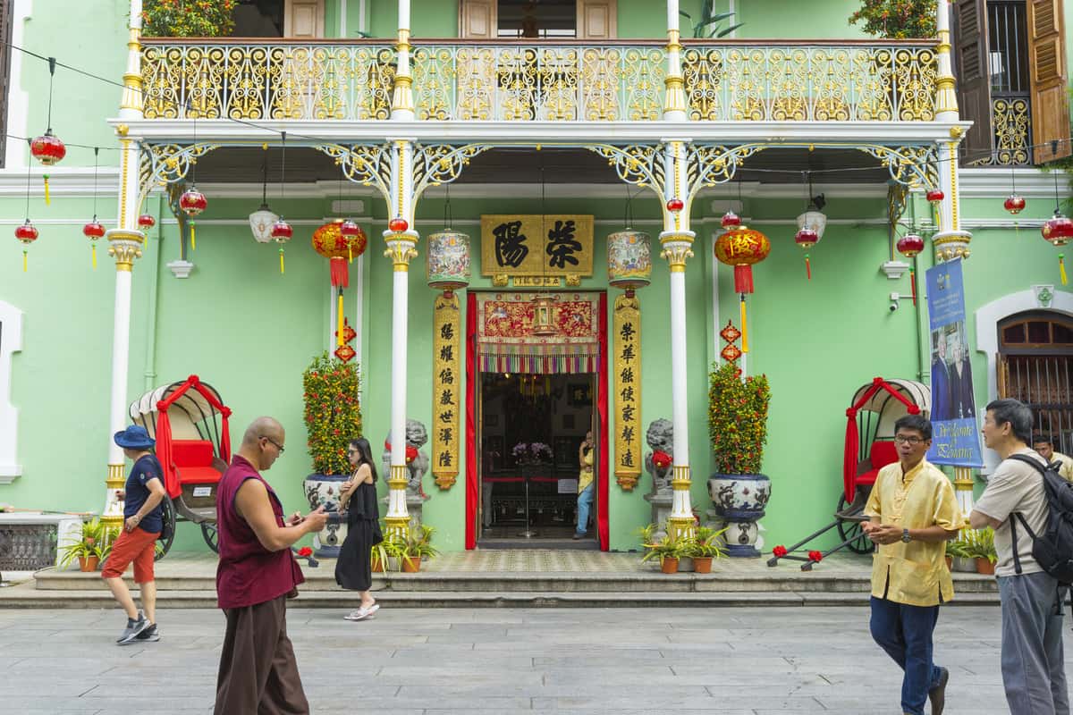 places to visit in Penang - Entrance of a colorful green museum with Chinese lanterns.