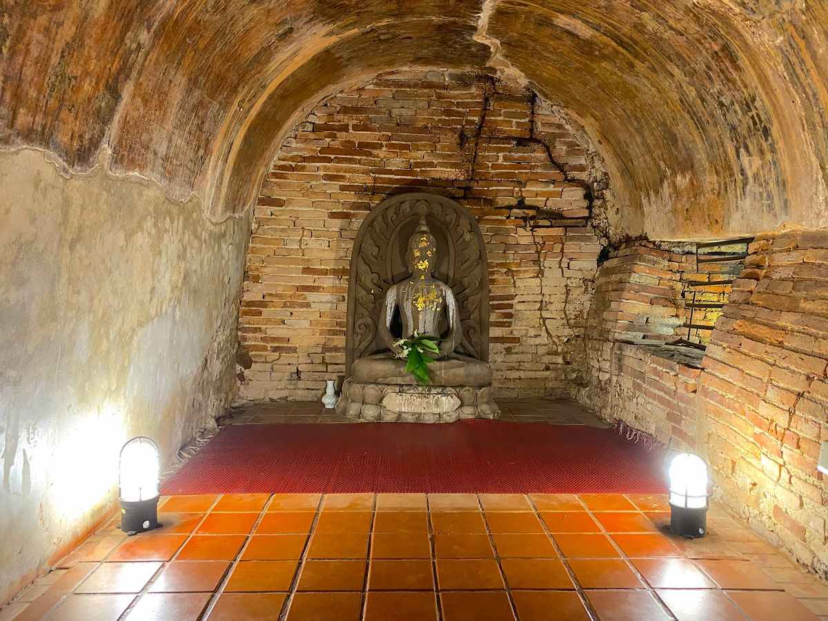 Buddha in tunnel Wat Umong Chiang Mai at night