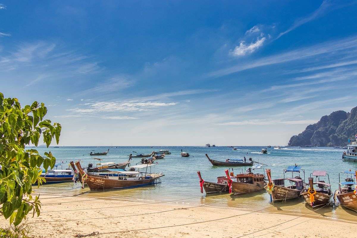 Thai longtail boats on a beach.