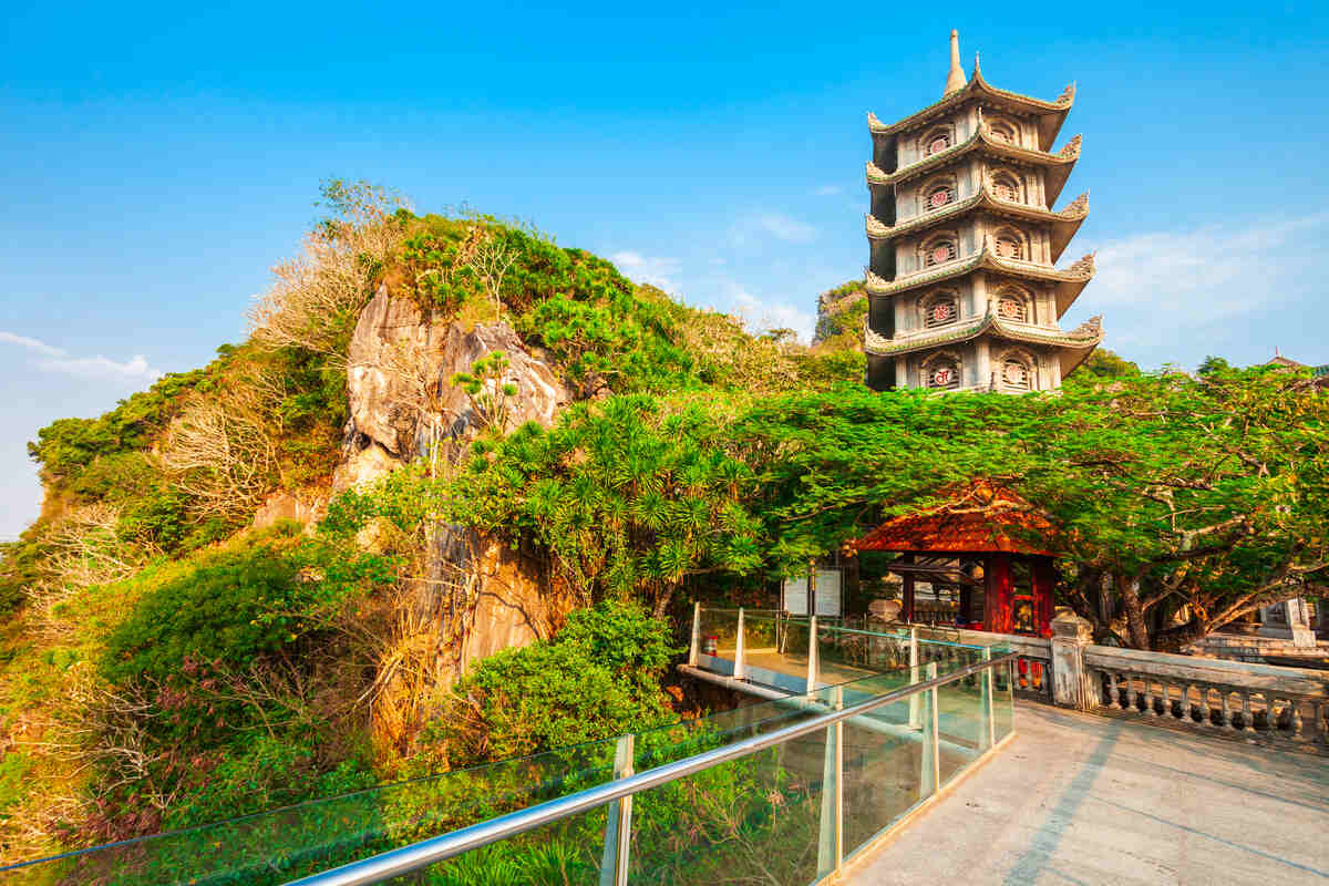 Pagoda atop a verdant hillside at the marble mountains in Da Nang. Marble mountain tours