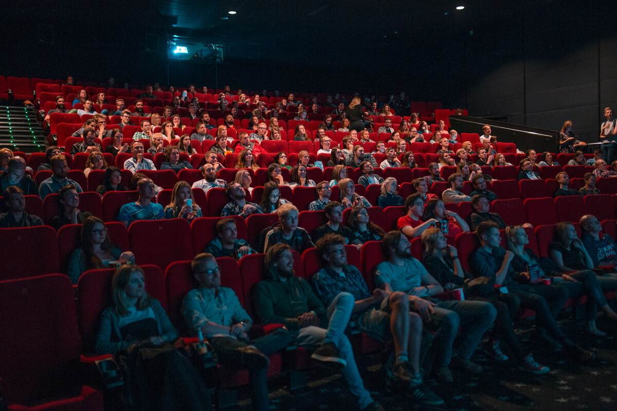 Audience in a red-seated theater.