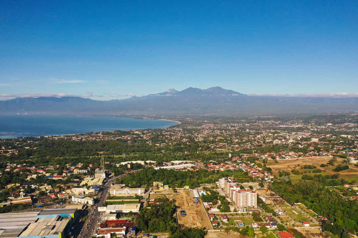 Aerial view of Davao City with mountains in the background