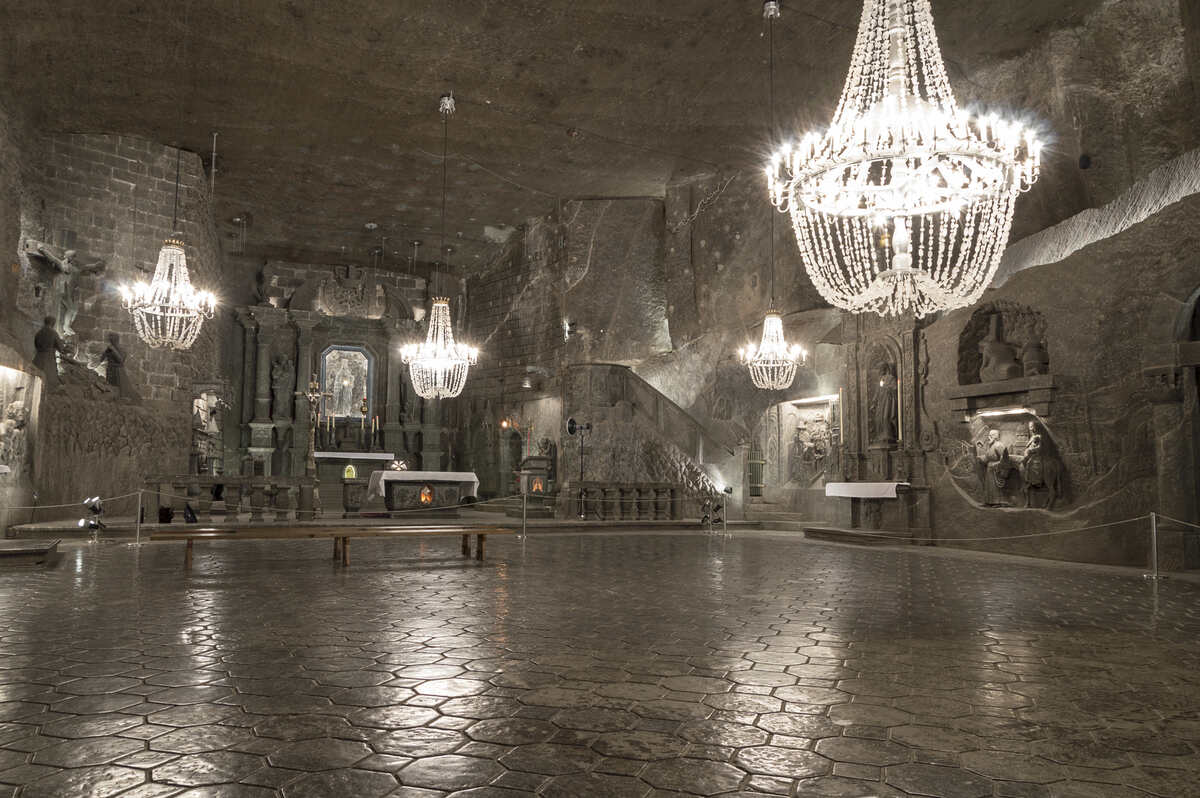 Grand interior of a salt mine in Poland with chandeliers.