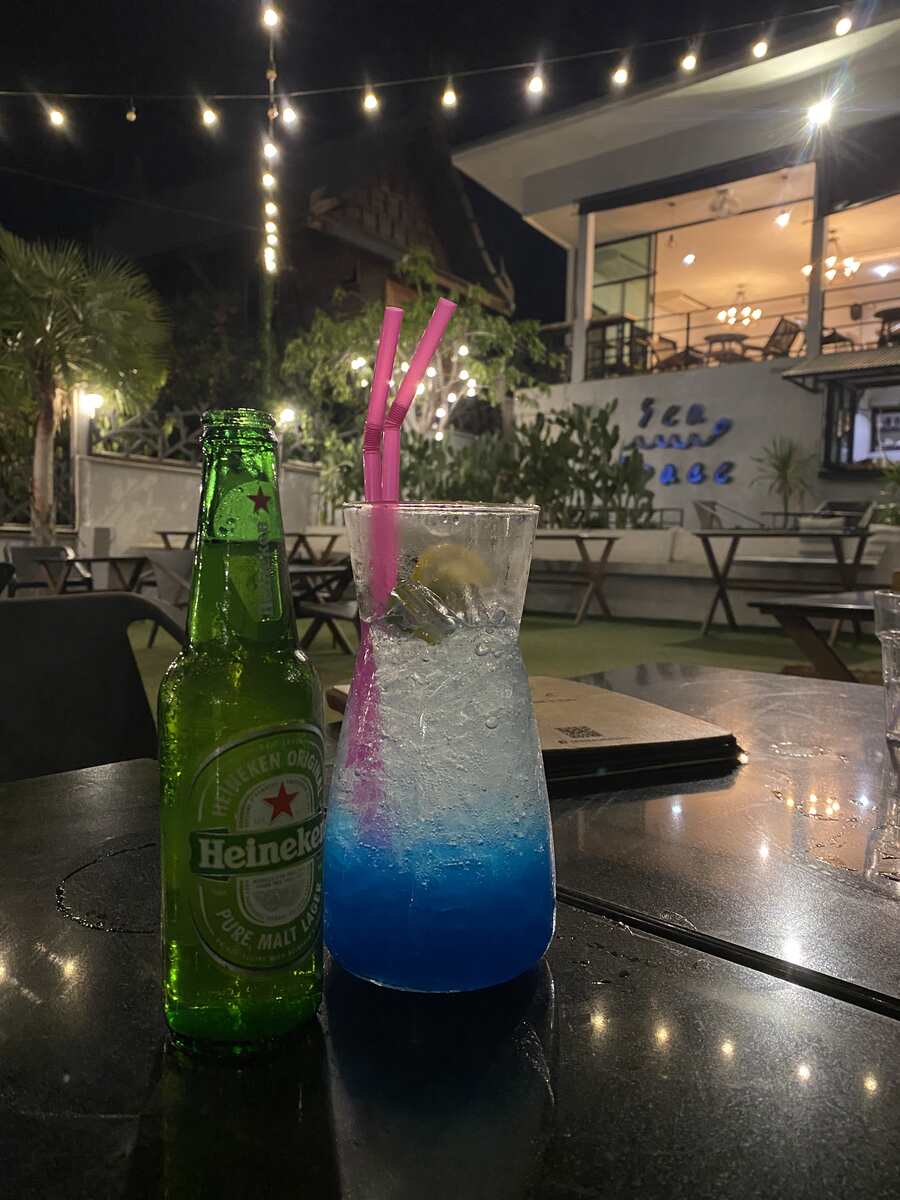 Tall cocktail with a straw in a bar