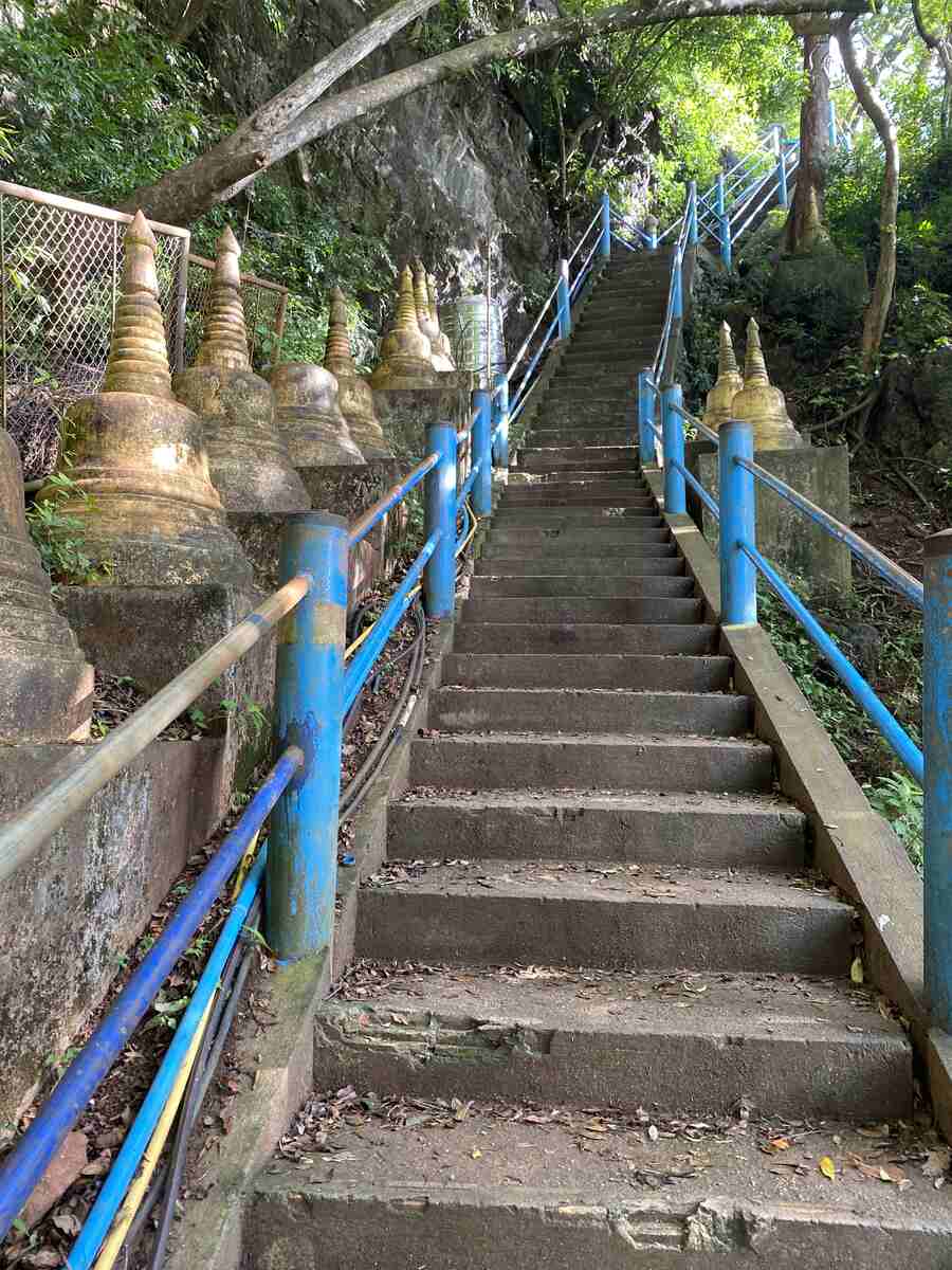 Stairs with small Buddhist pagodas on a trek in Southern Thailand