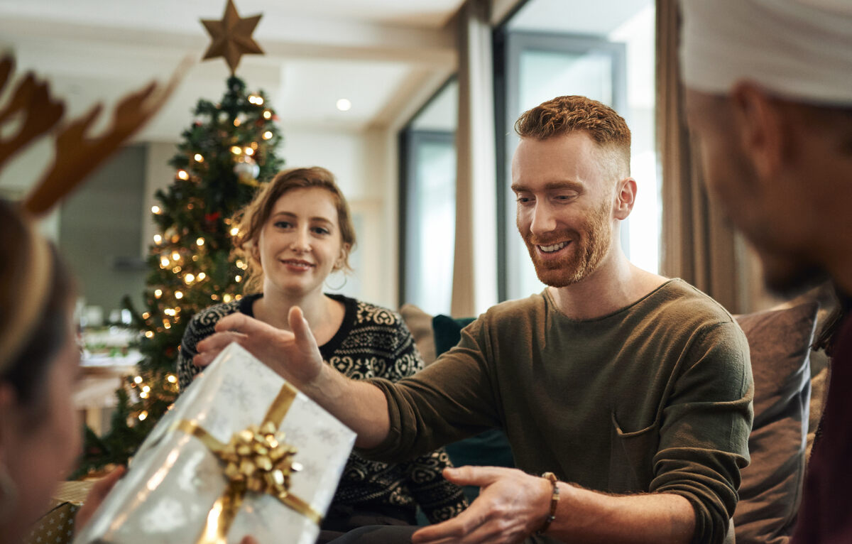 Couple with smartphones and Christmas decor.