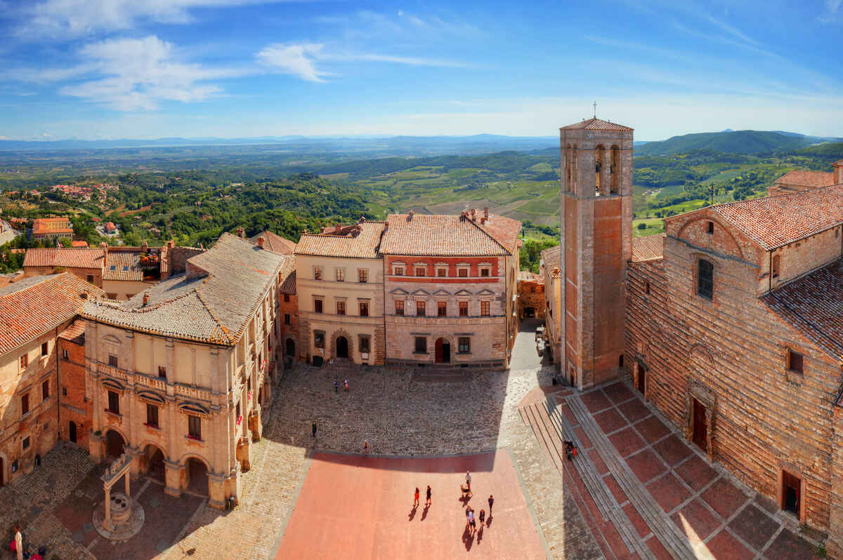 Aerial view of an Italian piazza with towers.