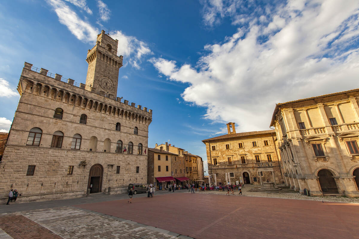 Historical town square with people. Things to do in Montepulciano