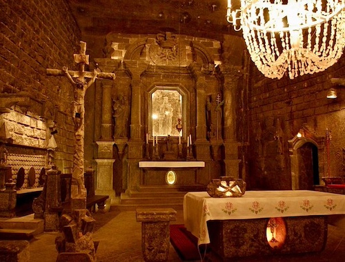 Ornate underground chapel with chandeliers.
