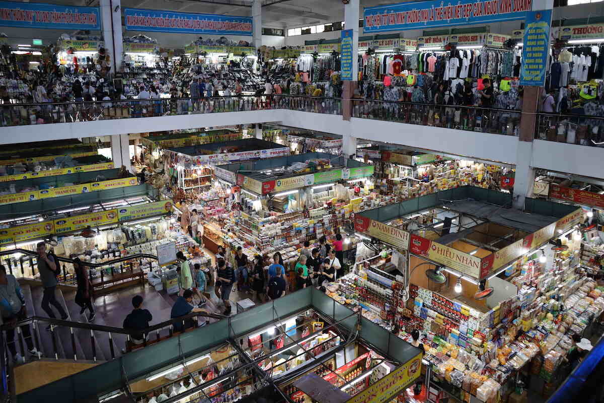 Busy indoor market with overhead view.