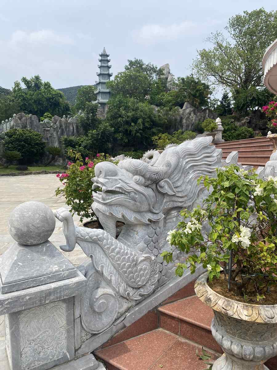Intricate dragon sculpture in a temple garden.
