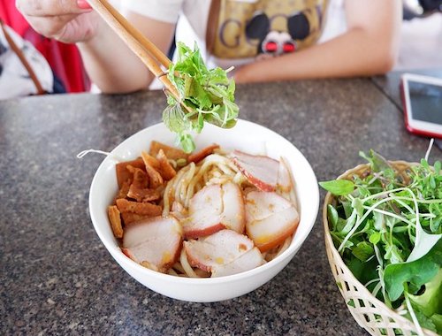 Vietnamese noodle dish with herbs.