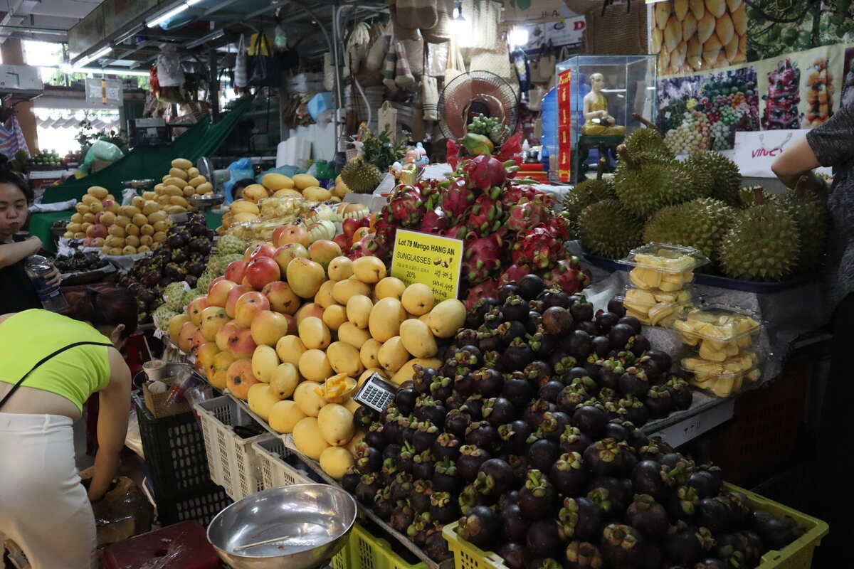 Fruit vendor with an assortment of tropical fruits.