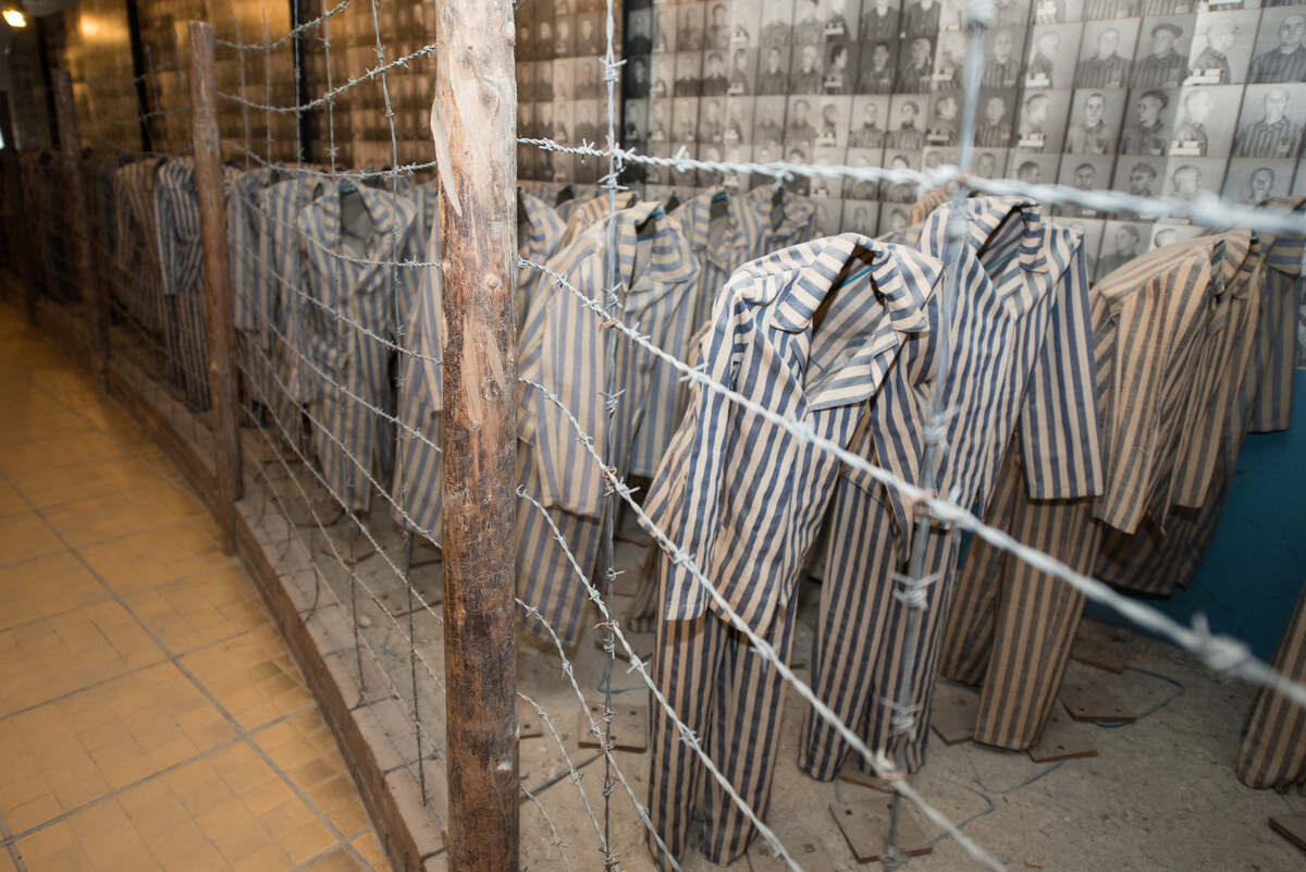Barbed wire fence with clothes of prisoners at Auschwitz
