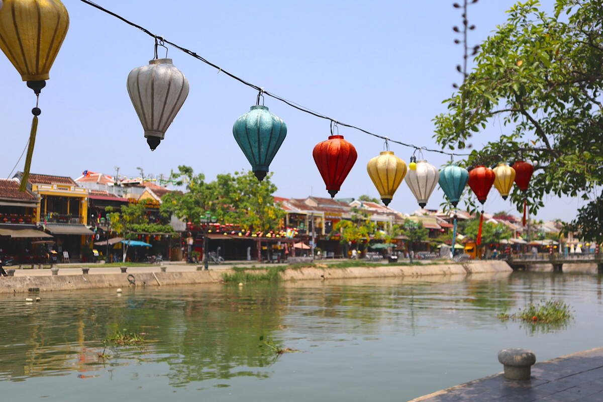 Lanterns above a calm river in Hoi An.