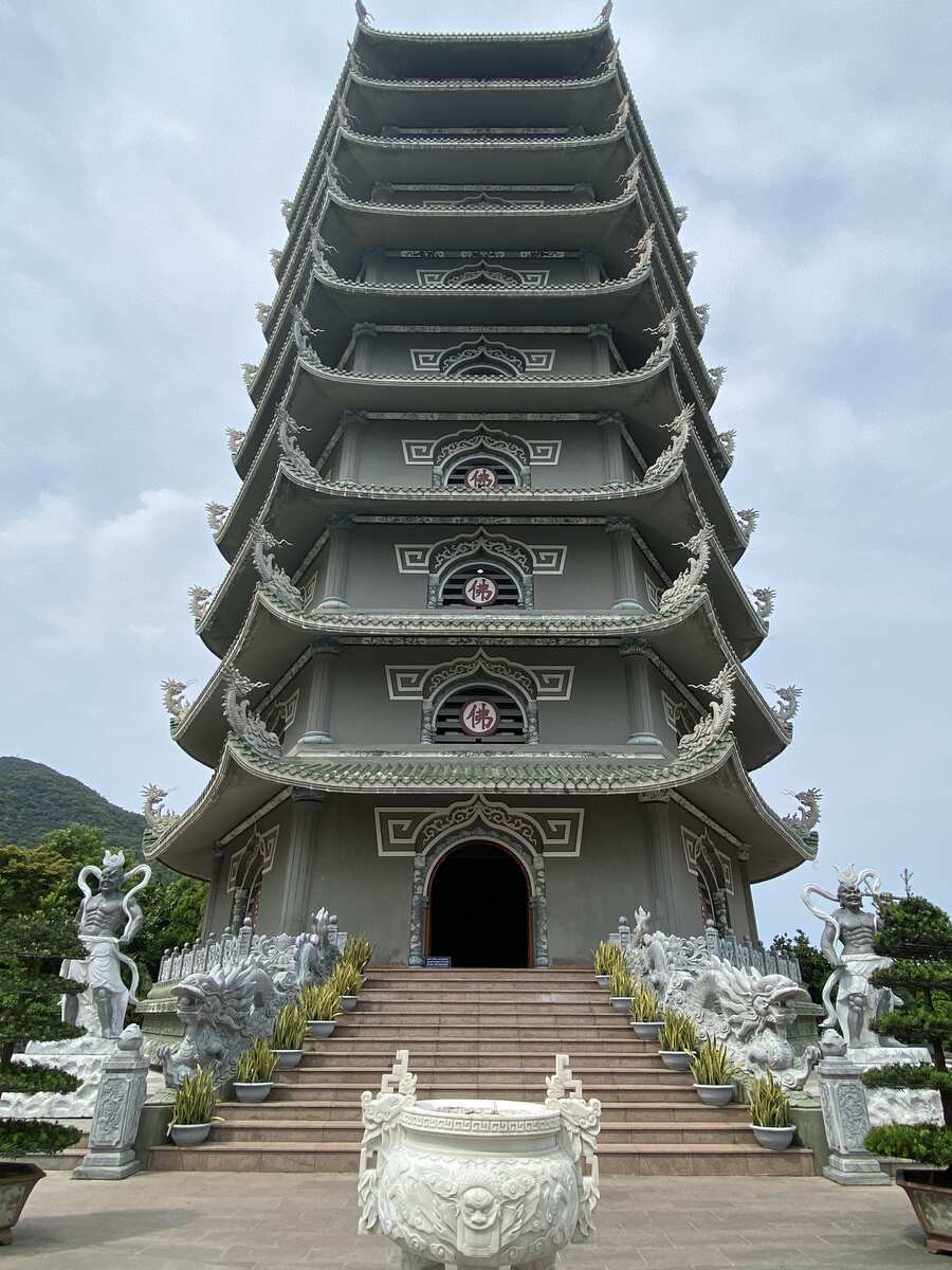 Multi-tiered pagoda surrounded by greenery.