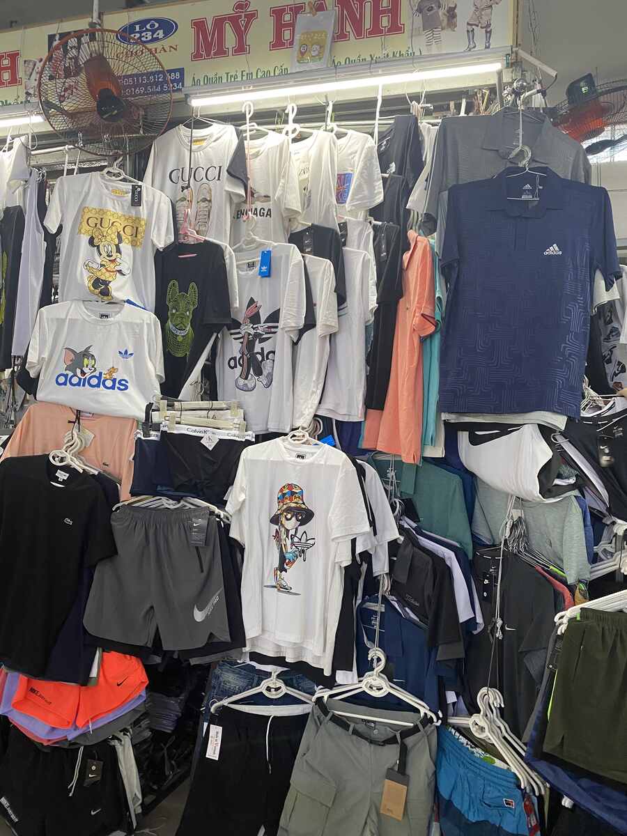 Clothing store with sports brands and various apparel.