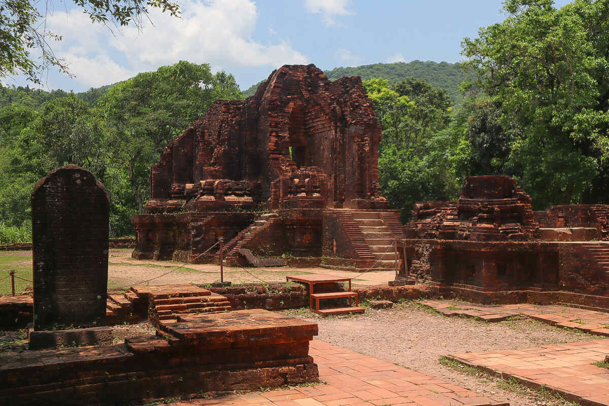 Ruins of a historical temple complex with sculptures.