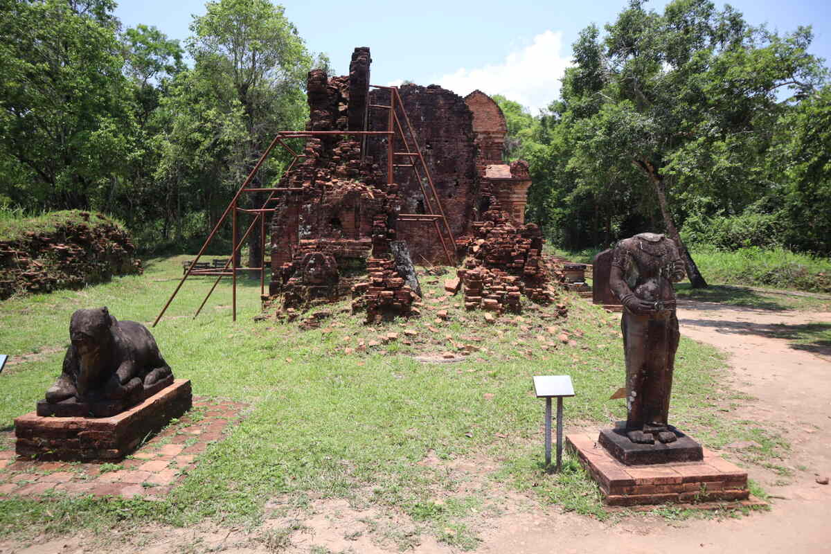 Ruins of a historical temple complex with sculptures in My Son Sanctuary.