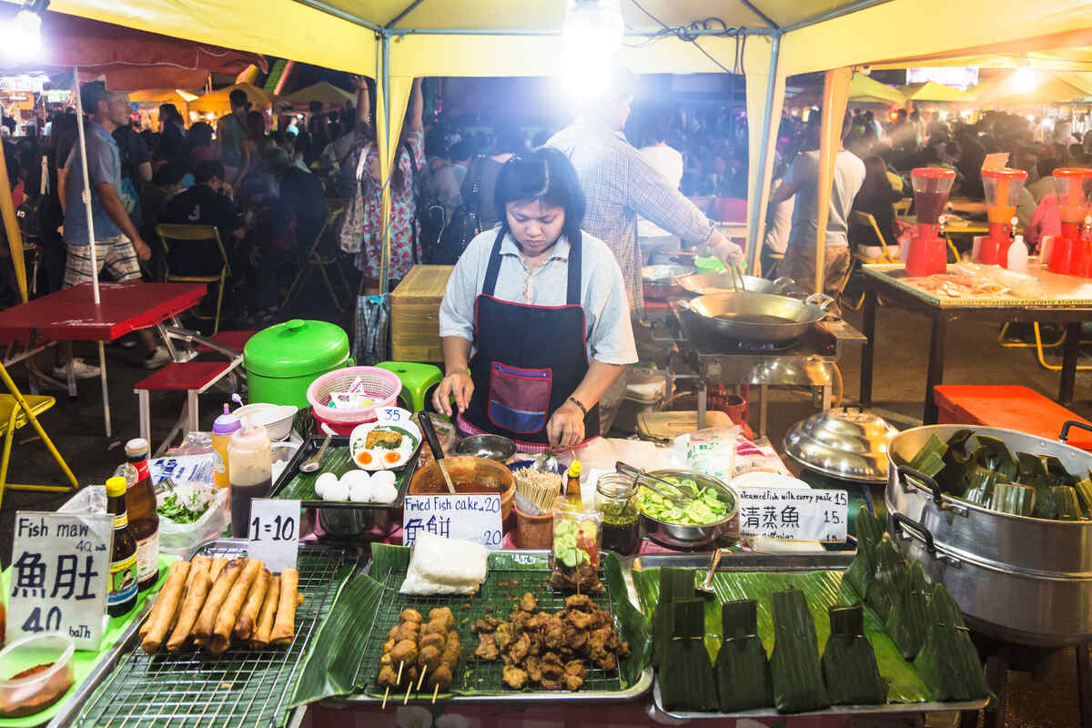 Night street food vendor cooking.