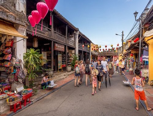 Busy walking street in Hoi An at twilight.