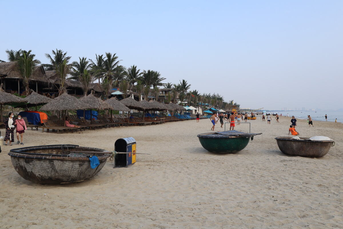 Serene beach with round boats on sand.
