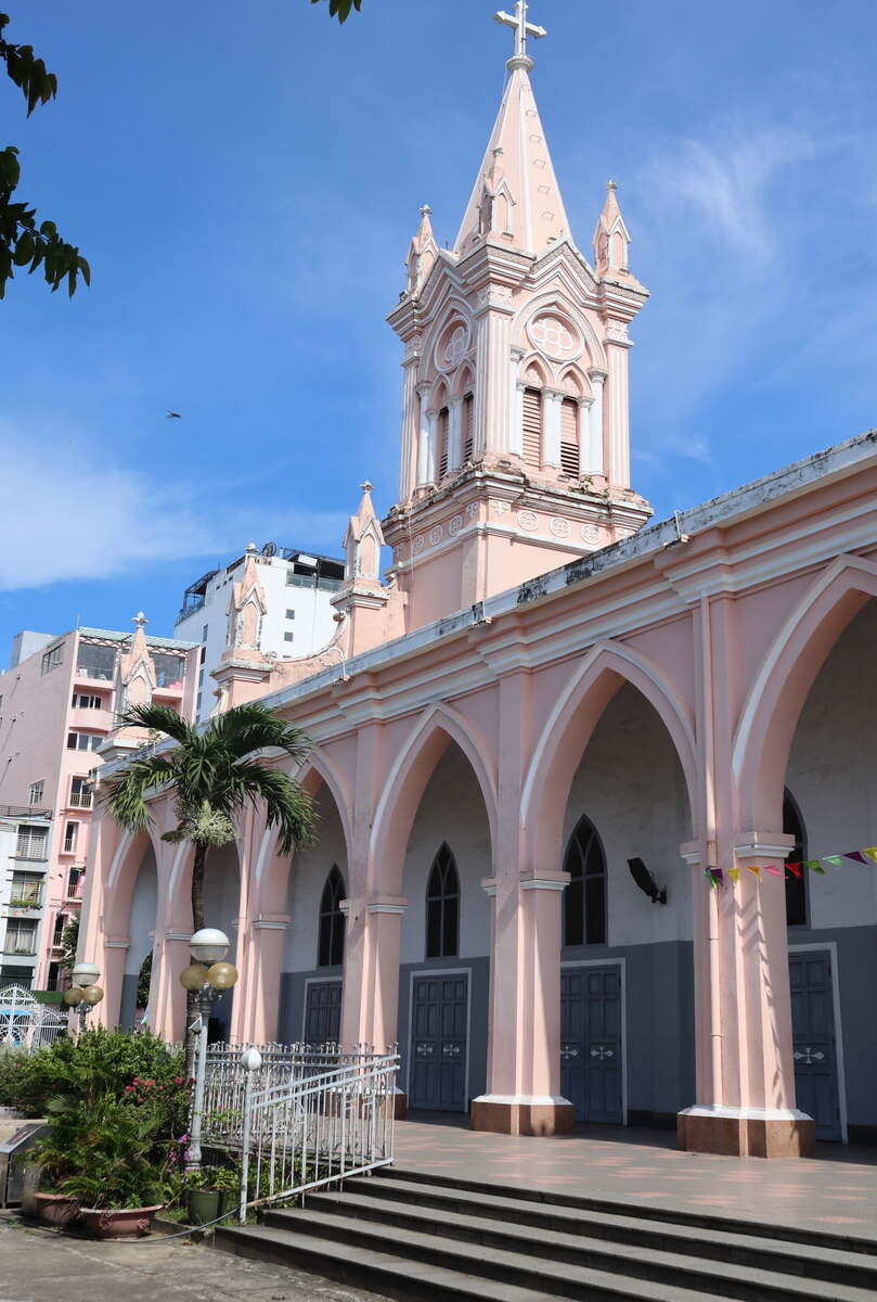 Colonial-style pink church building with arched windows.