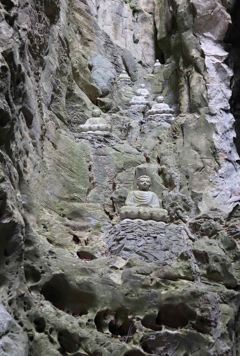 Carved rock wall with Buddhist figures.