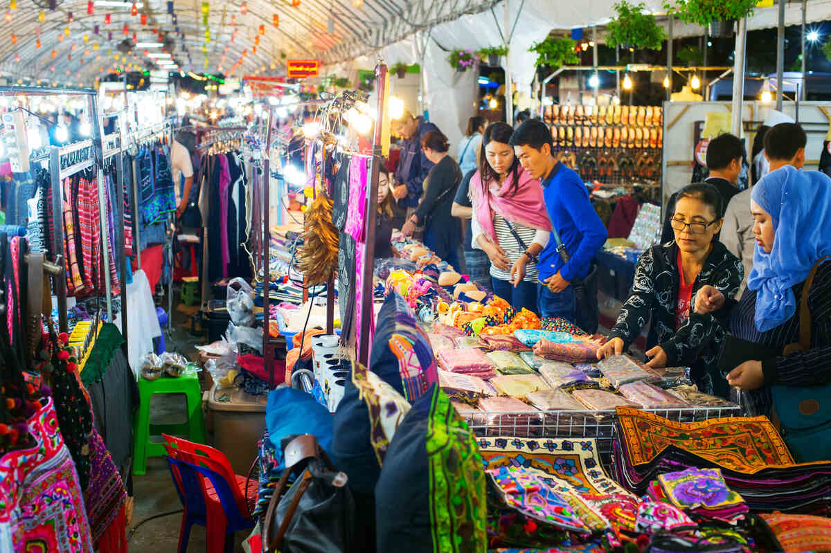 tourists checking the night market with clothes and souvenirs