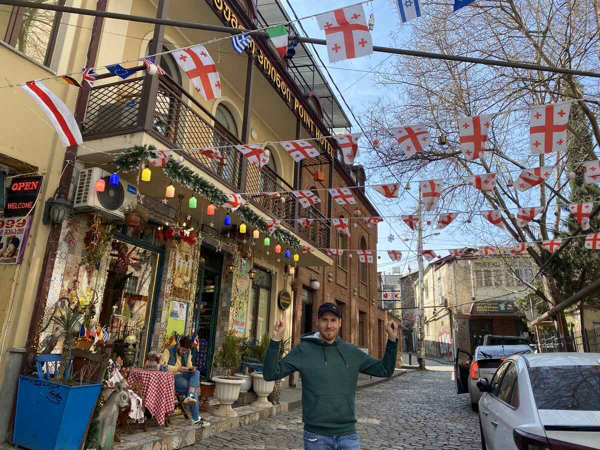 Man-with-Georgian-flags-in-Tbilisi-Georgia