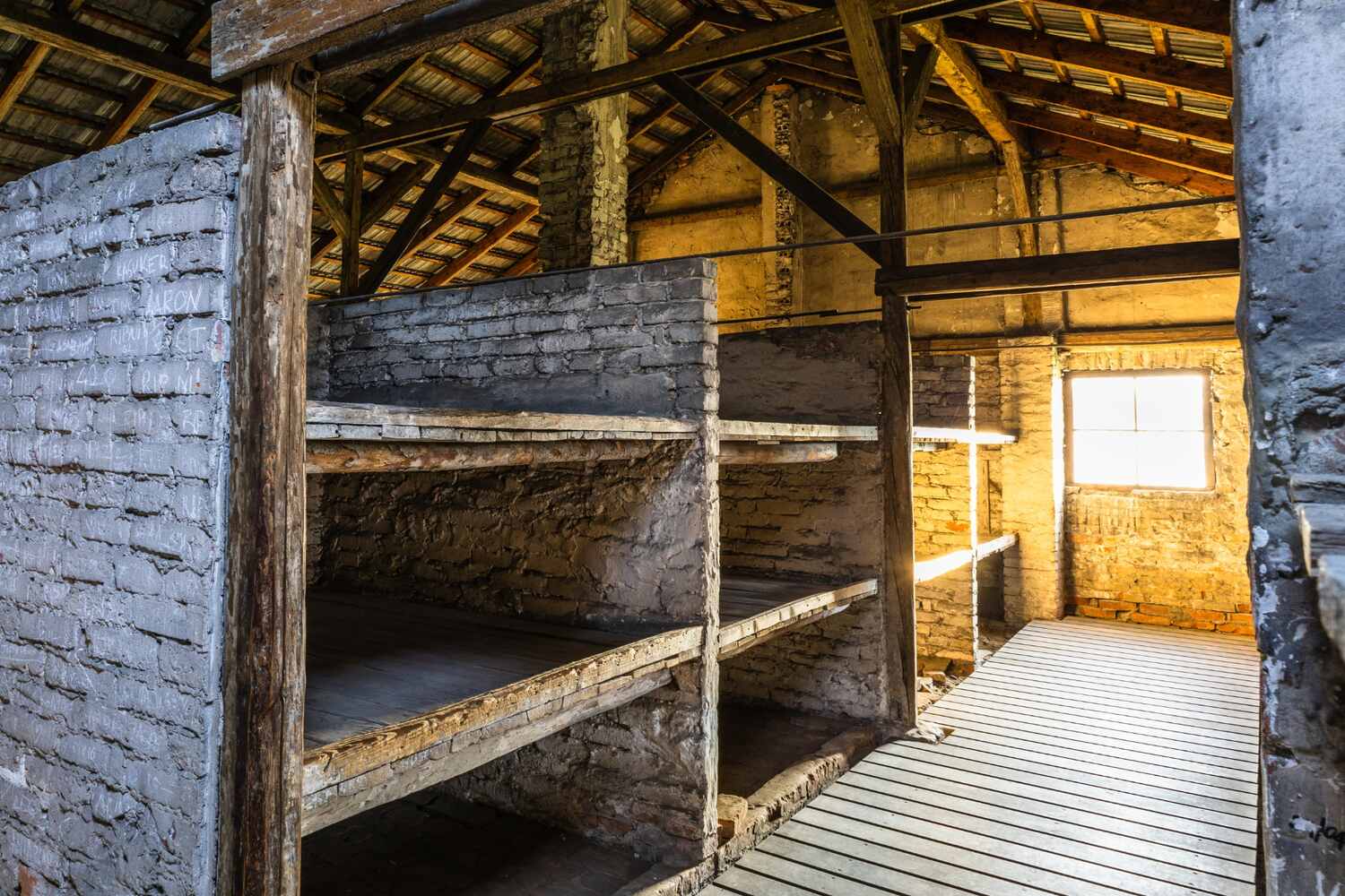 Wooden bunks in a concentration camp barracks.