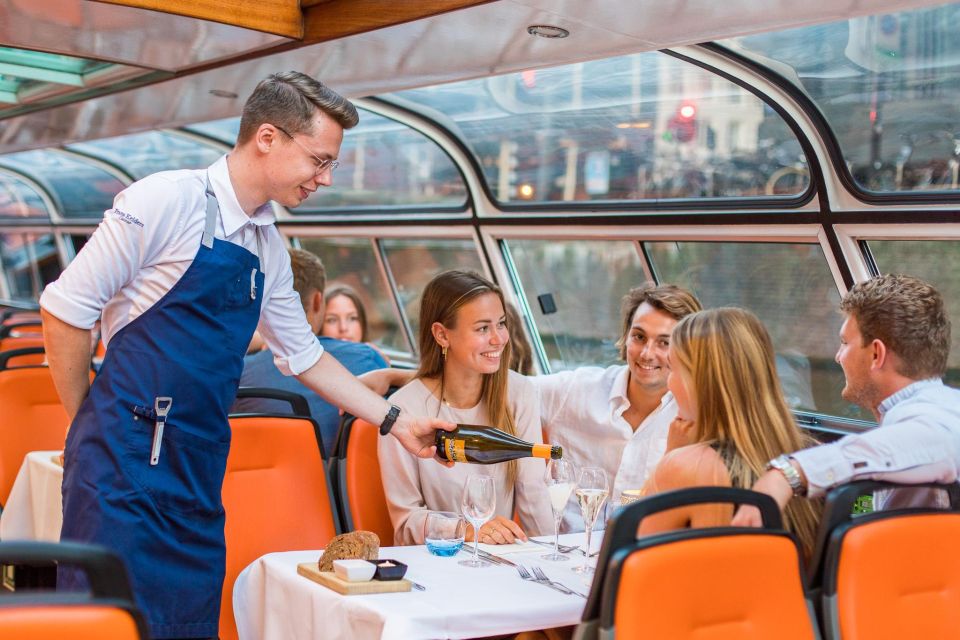 People dining and conversing in a retro boat in Amsterdam.