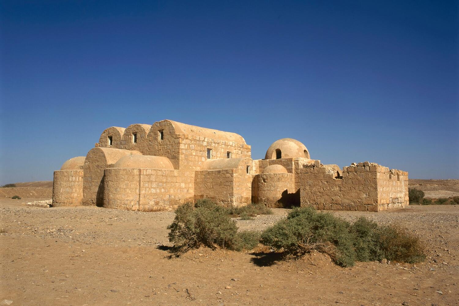 Ancient fortress ruins in a desert landscape.