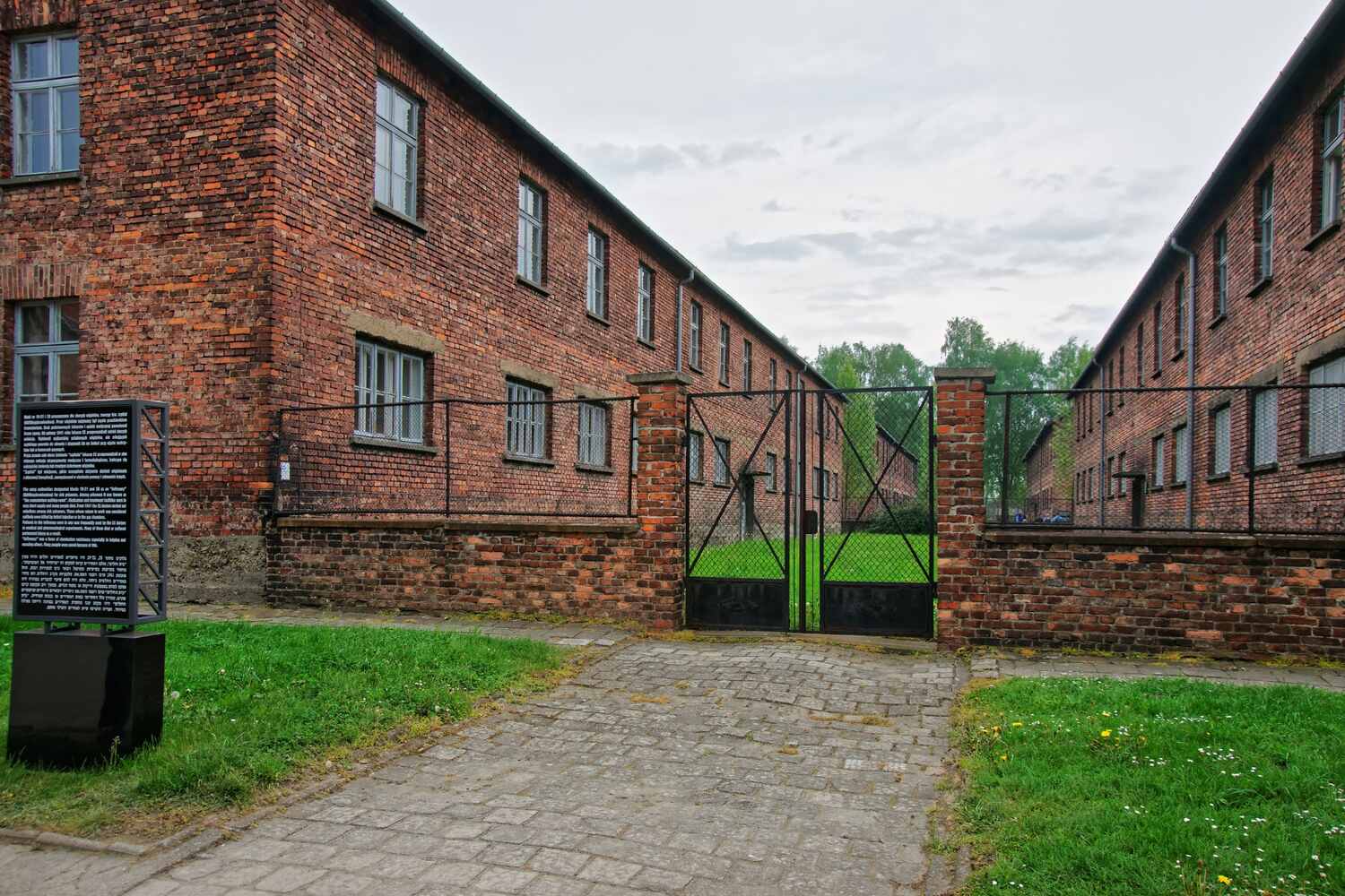 Courtyard of a red brick prison or barracks.