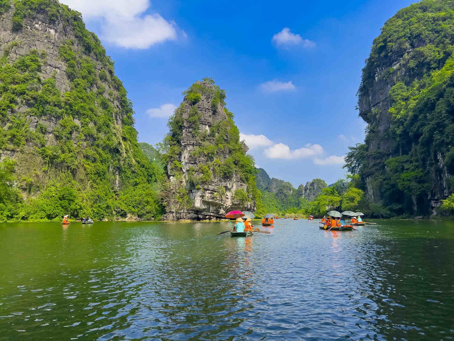Boat ride amidst the towering limestone karsts of Tam Coc in Ninh Binh.