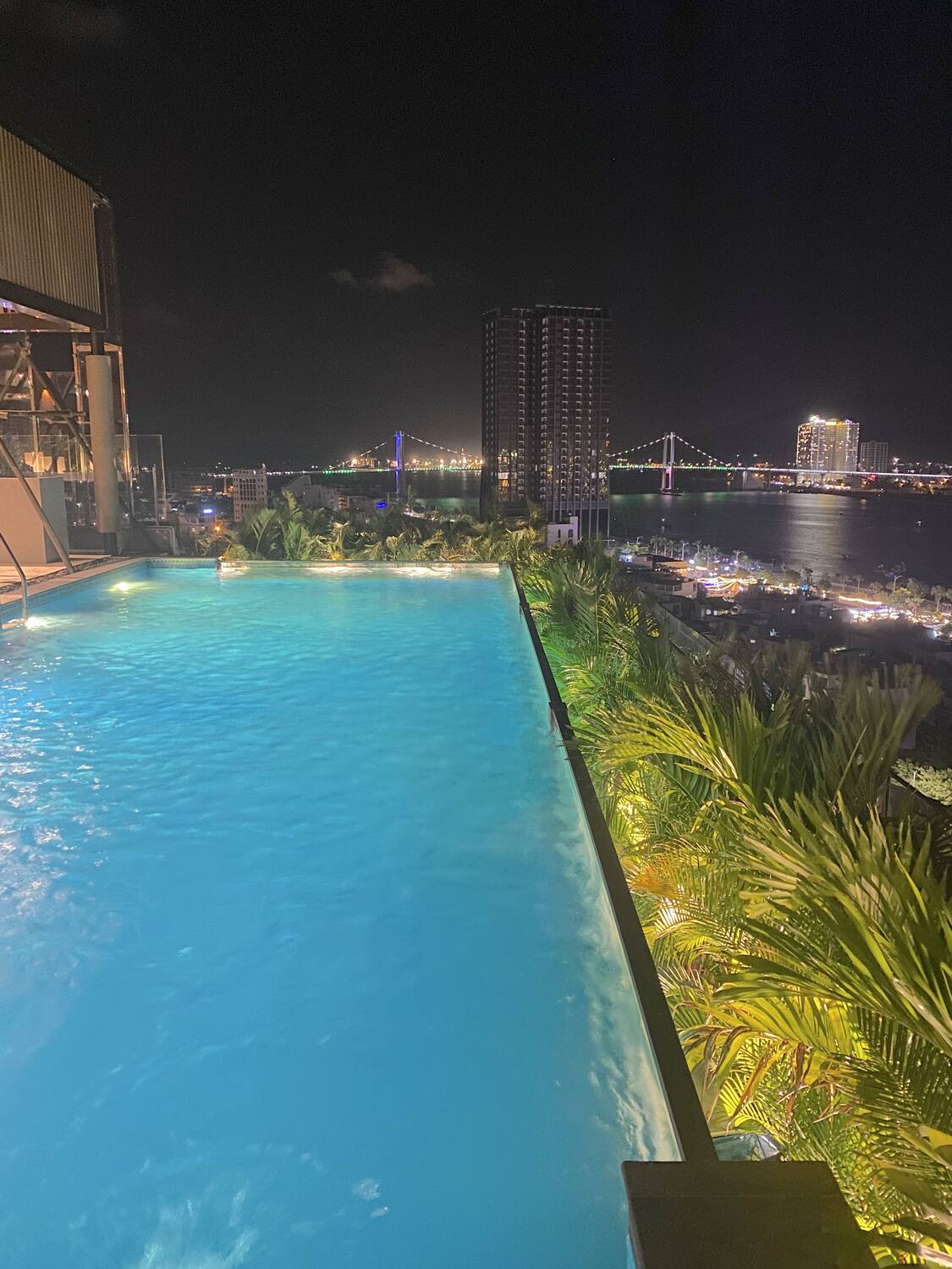 Nighttime poolside view at a sky bar in da nang