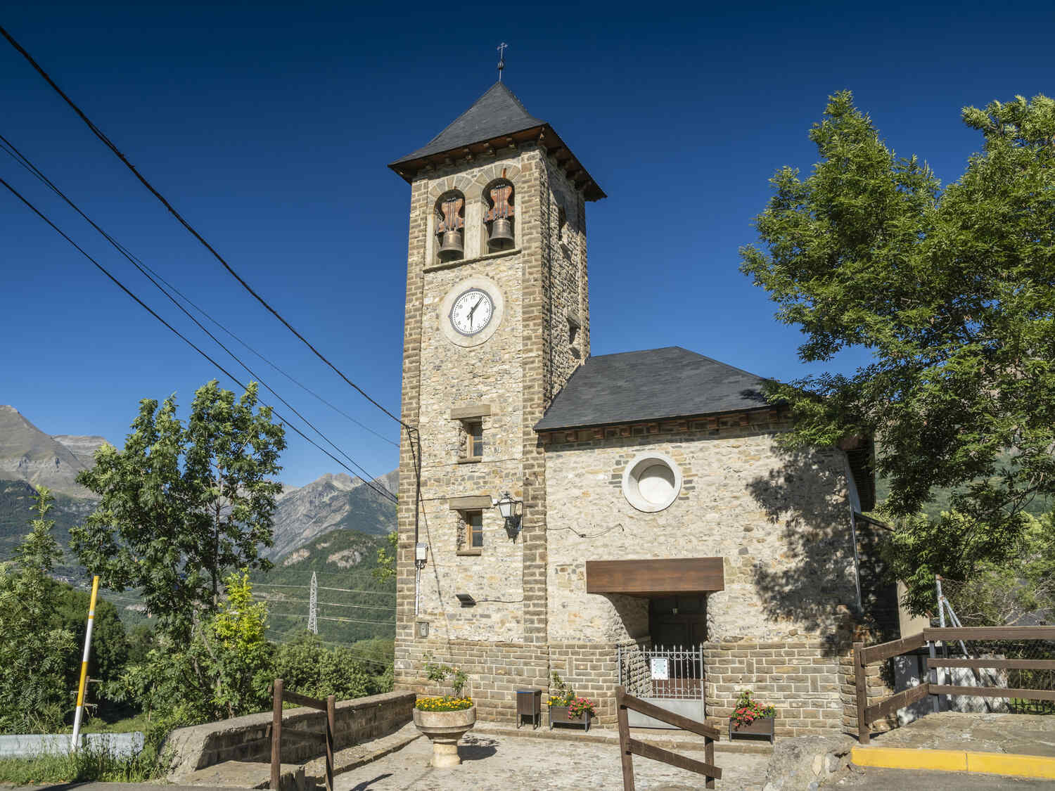 Traditional stone clock tower in a small village of the Spanish Pyrenees with clear skies